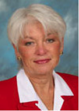 A woman with white hair and wearing red.